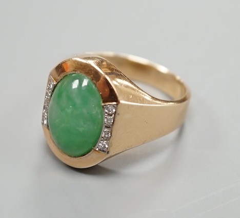 A 14k, cabochon jade and diamond chip set dress ring, size R/S, gross 7.6 grams.